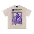 A light beige t-shirt featuring a vintage comic book cover graphic for 'Dungeon Kings Comics' with a purple and green 'Pimp Trick Gangsta Clique' illustration.