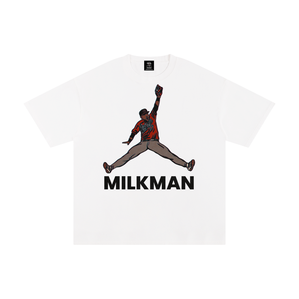 A white short-sleeve crewneck t-shirt featuring a graphic of Colton Cowser in orange and black orioles jersey mid-homerun rob, with the word 'MILKMAN' printed in bold black letters underneath.